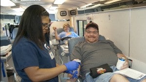 Phlebotomist Kourtney Nolen helps Robbie Deavors and Misty Jackson donate blood on a mobile blood drive in Clanton.