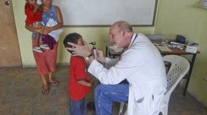  Dr. Jon Binkerd, M.D., administers routine check-ups for Guatemalan children.