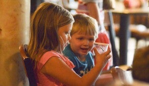 Anna and Stephen Mahan look at a jar of caterpillars during the summer children’s program, “God’s World.” 