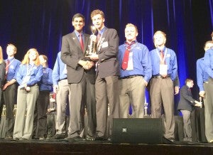 Dylan Levering and Fletcher Brantley stand on stage to receive their second- place award in technology problem solving at a competition held June 28-July 2 in Texas. Levering and Brantley are students at Jemison High School. 
