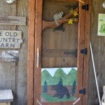 The entrance to The Old Country Barn Gift Shop is rustic and offers customers a glimpse of what awaits inside the store.