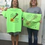 Lynsie Glasscock and Erica Hilyer pose with the 2016 Peach Jam T-shirts. Hilyer (left) created the design that will grace the front of this apparel. (Contributed Photo)