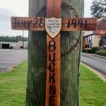 A wooden cross was placed on a telephone pole in front of Taco Bell on U.S. Highway 31 to mark the location where Buckner’s accident occurred. (Contributed Photo)