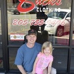 Joe Bice stands in front of Buck’s Clothing Store with his 4-year old daughter Alli Kate Bice.