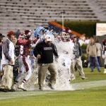 Maplesville players douse head coach Brent Hubbert with a cooler of ice water as time runs out in the game.